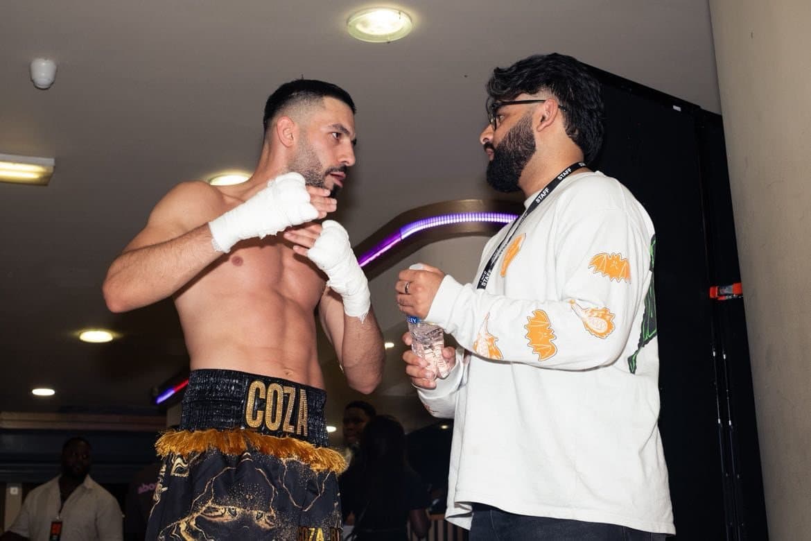 Corrie Mustafa, hands wrapped and wearing his COZA shorts, with SHWDWN co-founder Joshua Chumber backstage at Zumi Fight House League 6.0